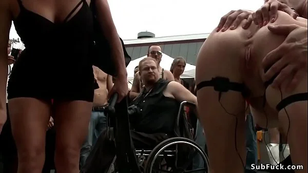Blonde slut is caned outdoors at fair