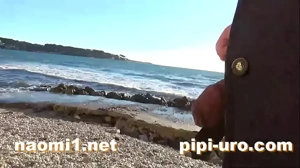 public pissing couple on a beach